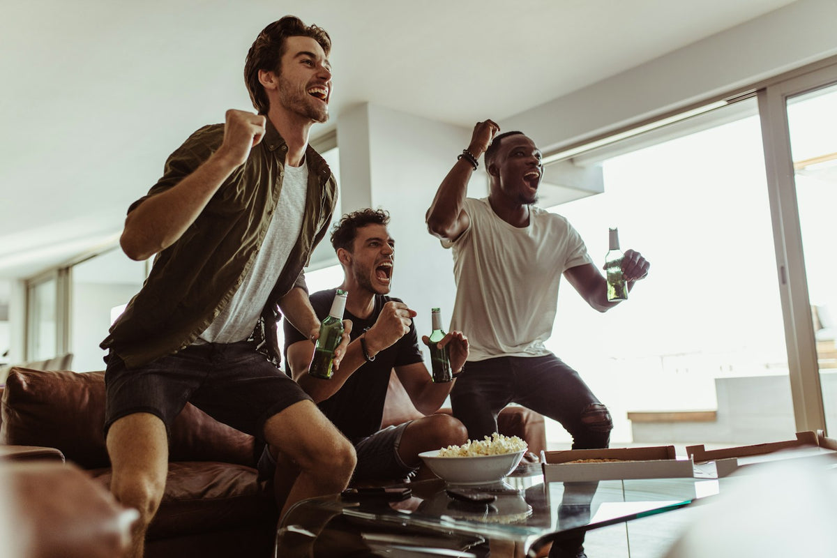 Friends cheering while watching the game